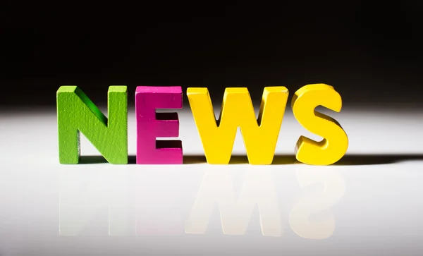 Multicolored word news made of wood. — Stock Photo, Image