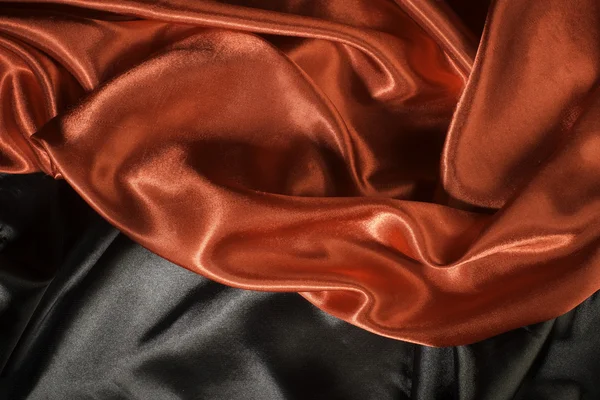 Lesklá černá a červená saténová tkanina — Stock fotografie