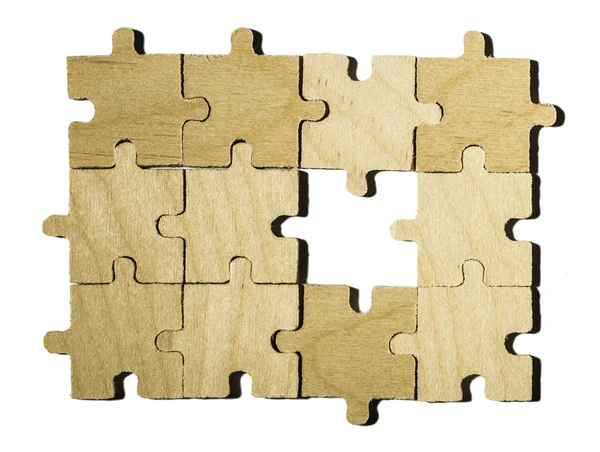 Wooden puzzle on white background. — Stock Photo, Image