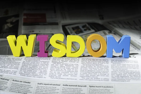 Word wisdom on newspaper — Stock Photo, Image