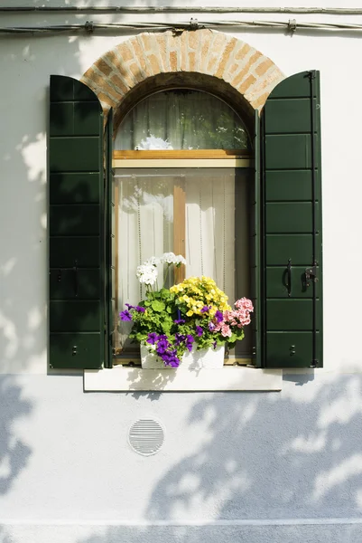 Venetian windows with flowers — Stock Photo, Image