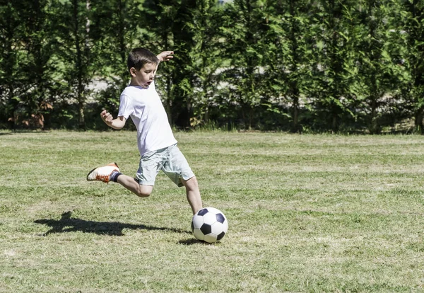 Bir stadyumda futbol oynayan çocuk — Stok fotoğraf