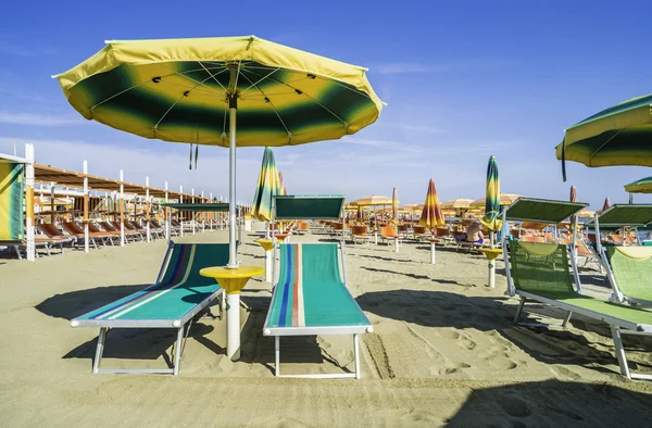 Solstolar och parasoller på stranden — Stockfoto