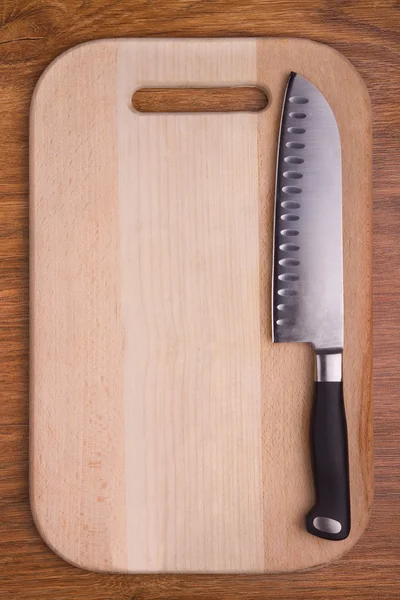 Sharp knife on cutting board — Stock Photo, Image