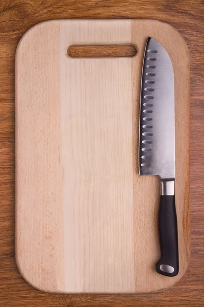 Sharp knife on cutting board Stock Image