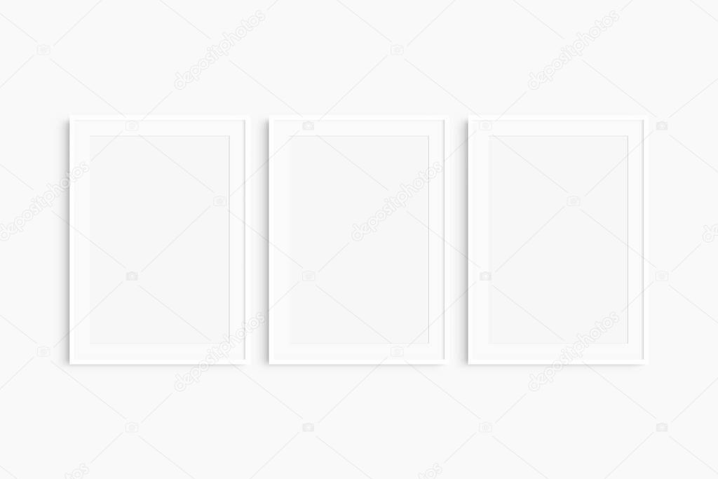 Frame mockup 5x7, 50x70, A4, A3, A2, A1. Set of three thin white frames. Gallery wall mockup, set of 3 frames. Clean, modern, minimalist, bright. Portrait. Vertical. Passepartout/mat opening in 2:3 aspect ratio.