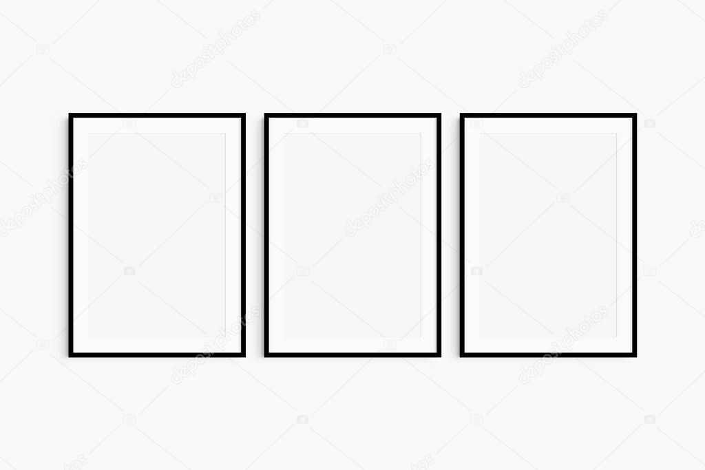 Frame mockup 5x7, 50x70, A4, A3, A2, A1. Set of three thin black frames. Gallery wall mockup, set of 3 frames. Clean, modern, minimalist, bright. Portrait. Vertical. Passepartout/mat opening in 2:3 aspect ratio.