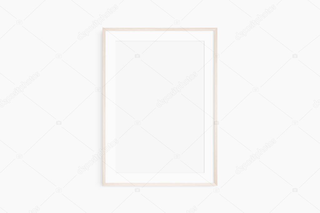 Frame mockup 5x7, 50x70, A4, A3, A2, A1. Single light wood frame mockup. Clean, modern, minimalist, bright. Portrait. Vertical. Passepartout/mat opening in 2:3 aspect ratio.