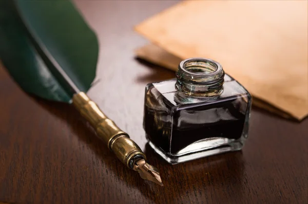 Quill pen, inkwell and paper