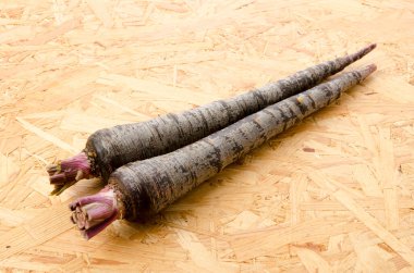 Tahta arka planda siyah havuç