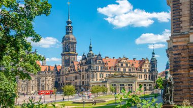 Cityscape over historical and touristic center in Dresden downtown, old clock tower near Cathedral of Holy Trinity and theater square, Dresden, Germany, at summer sunny day and blue sky