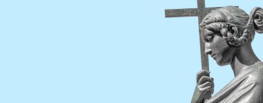 Dresden şehrinde, mavi gökyüzü arka planında, Almanya 'da, kopyalama alanı ile haç tutan, şehvetli, güzel bir kadının eski metal heykeli. Dini ve mimari mirası kavra