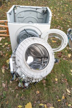 Pile of home bulky waste as wash machine disassembled prepared for pickup at the street in German city