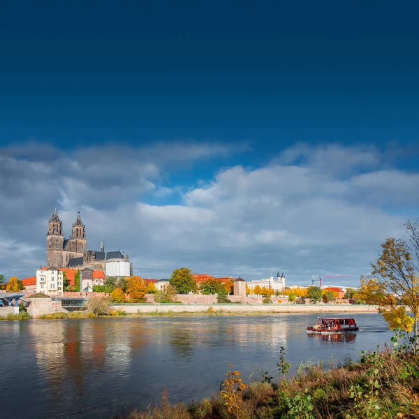 Cover page with Magdeburg historical downtown, Elbe river, city park and the ancient medieval cathedral in Spring colors at blue cloudy sky and sunny day, Magdeburg, Germany