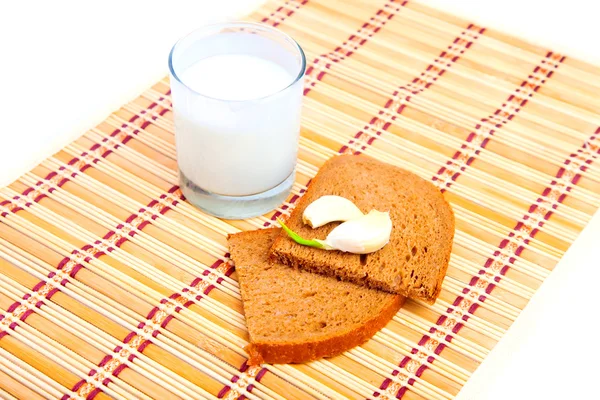 Bread, garlic and glass of milk — Stock Photo, Image