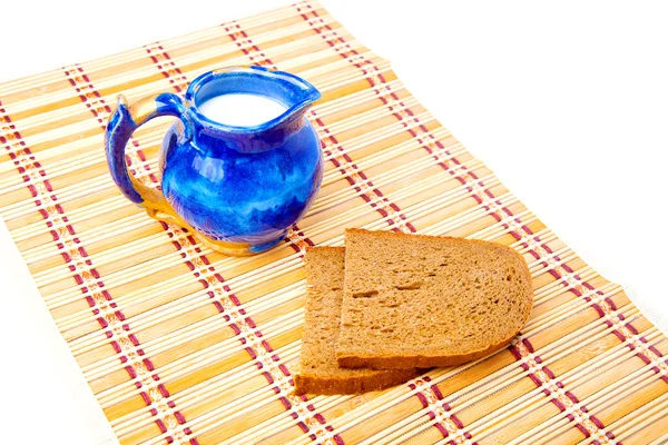 Bread and milk in blue jar — Stock Photo, Image