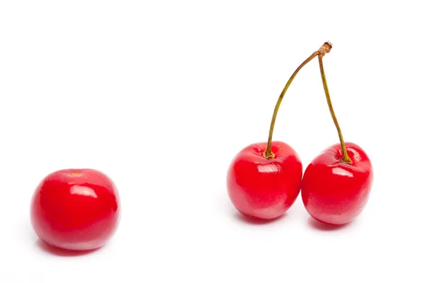 Two cherries against single cherry — Stock Photo, Image