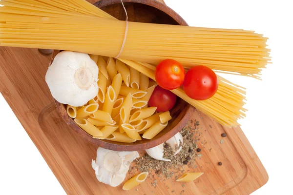 Kitchen board with pasta ingredients — Stock Photo, Image