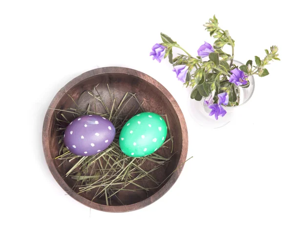 Eggs in a bowl and flowers — Stock Photo, Image