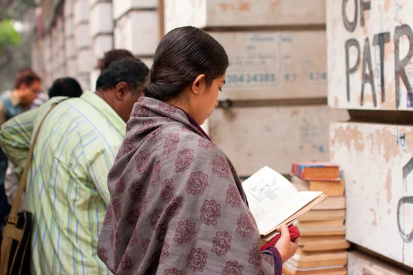 Asian woman read the book near the street book stall — Stock Photo, Image