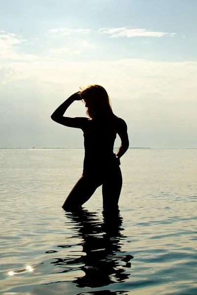 Silhouette of woman in the sea — Stock Photo, Image