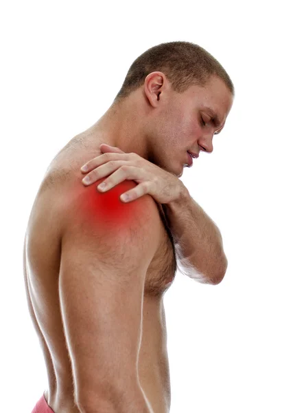 Young man suffering from pain in his shoulder. Isolated on white. — Stock Photo, Image