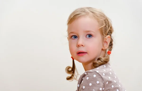 Portrait of a lovely little girl with blue eyes. Space for text — Stock Photo, Image