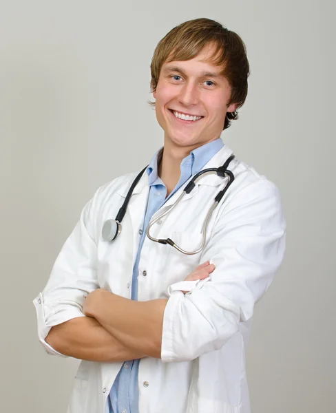 Happy male doctor with arms crossed. — Stock Photo, Image