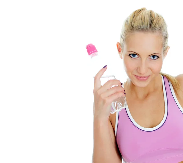 Pretty young female fitness trainer with bottle of water. Isolated on white — Stock Photo, Image