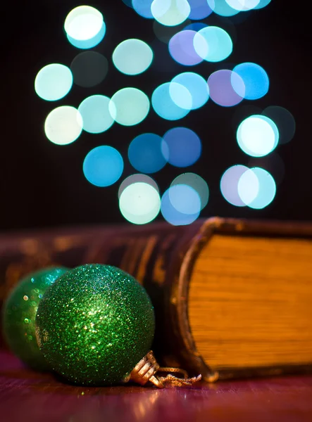 Old book and seasonal decorations on bokeh lights background