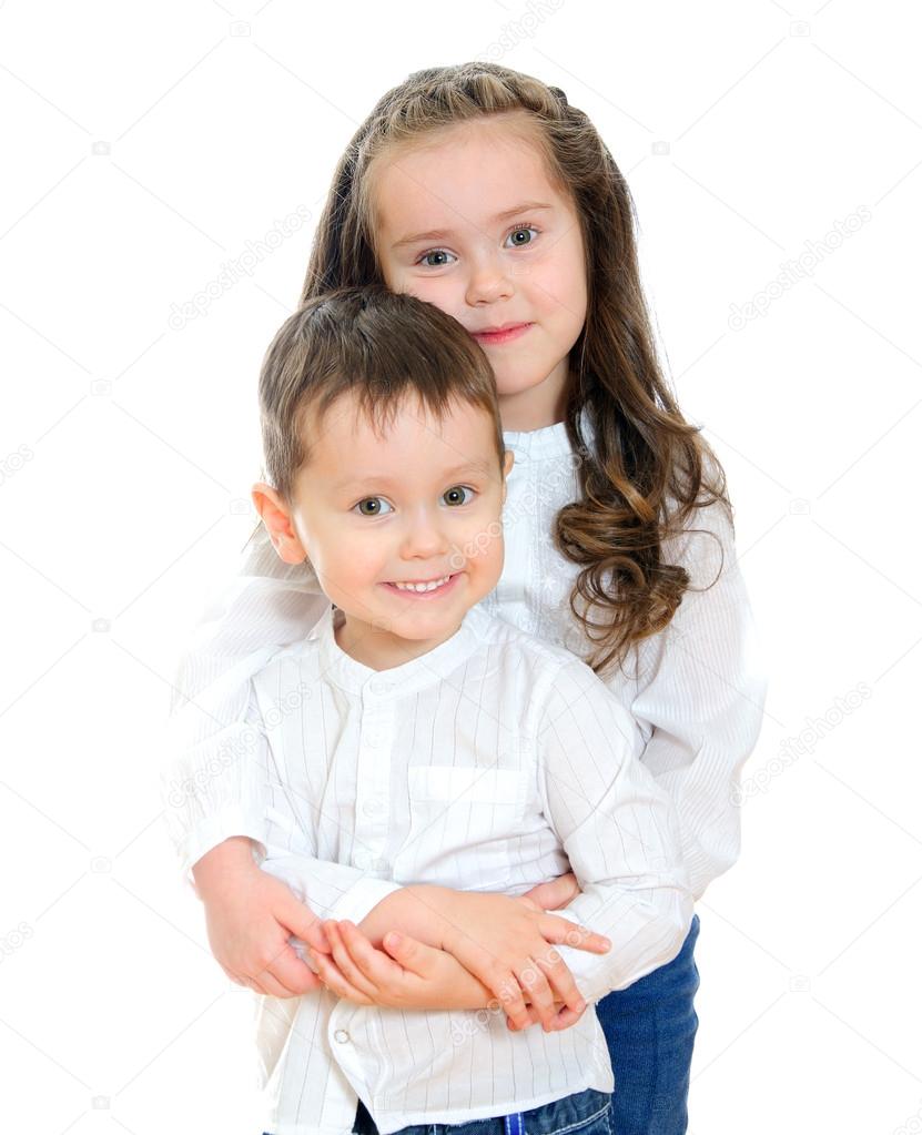 Little girl and boy hugging. Isolated on white