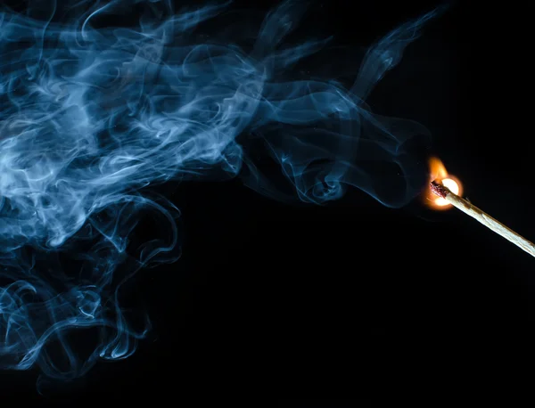 Encendido a juego con humo sobre fondo negro —  Fotos de Stock