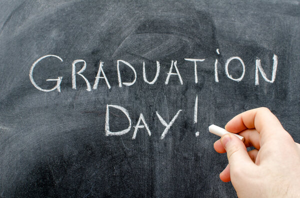 Graduation day text written with chalk on blackboard