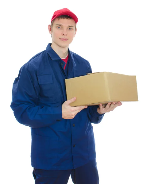 Young courier holding cardboard box. Isolated on white — Stock Photo, Image
