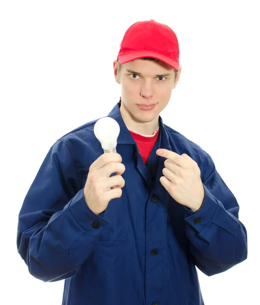 Jovem eletricista de uniforme com lâmpada. Isolado em branco — Fotografia de Stock