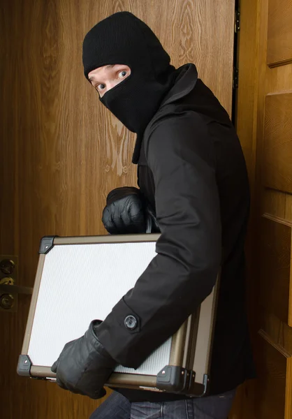 Male burglar stealing case with money — Stock Photo, Image