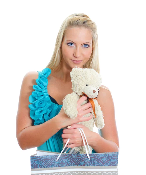 Young pretty woman with teddy bear and shop bag. Isolated on white — Stock Photo, Image