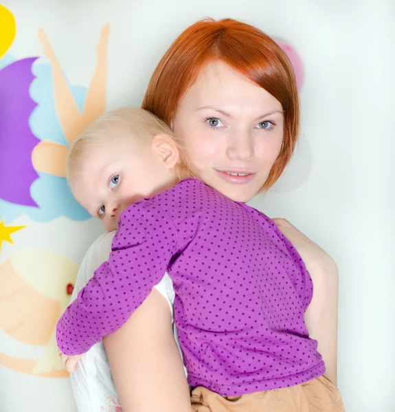 Young mother holding her little daughter — Stock Photo, Image