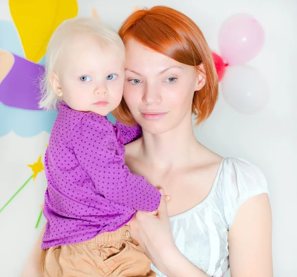 Young mother holding her little daughter — Stock Photo, Image