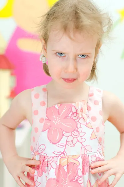 Portrait of little girl looking in to the camera with anger — Stock Photo, Image