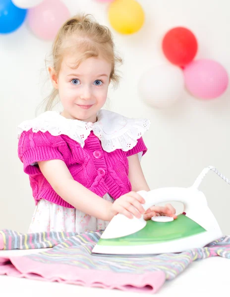 Cute little girl ironing clothes — Stock Photo, Image