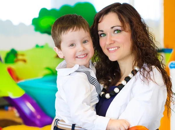 Portrait of woman and little boy in playroom — Stock Photo, Image