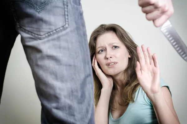 Man with knife coming to his wife. Home violence concept — Stock Photo, Image