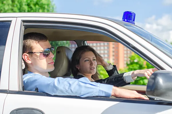 Two young detectives driving to crime scene. — Stock Photo, Image