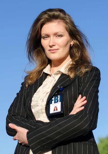 Young female criminalist on a sky background — Stock Photo, Image