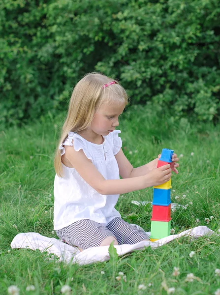 Bloklar parkta oynarken küçük kız — Stok fotoğraf