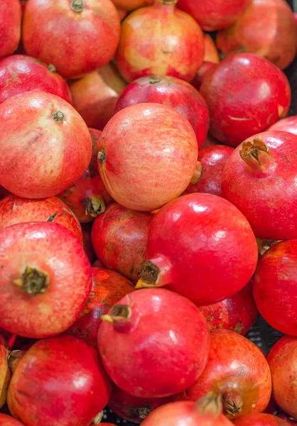 Lot of red fresh pomegranates closeup view — Stock Photo, Image