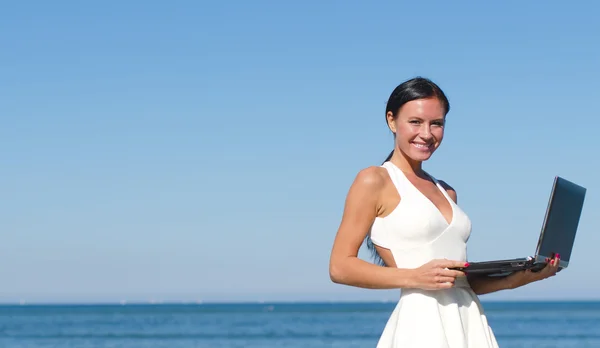 Attractive woman with notebook on the beach. Place for text — Stock Photo, Image