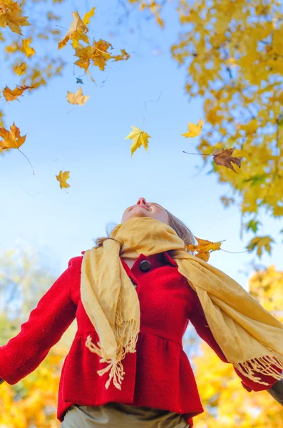 Happy woman throwing autumn leaves. Place for text — Stock Photo, Image