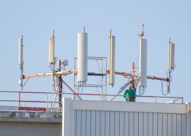 Six cellular towers on the roof clipart